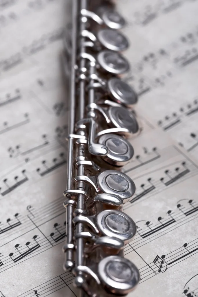 Close-up of a flute on sheet music background